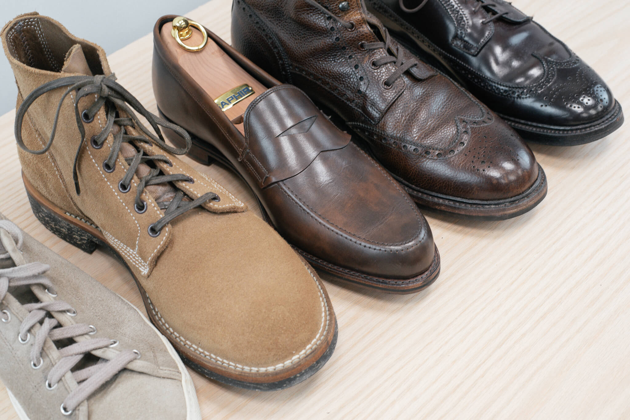 Leather Type Overview photo shoes left to right: Diemme Deerskin suede sneaker, viberg boondocker boot, allen edmonds wooster brown loafer, Crockett & Jones Islay boot in dark brown grain calf, Alden 975 long wing shell cordovan blucher