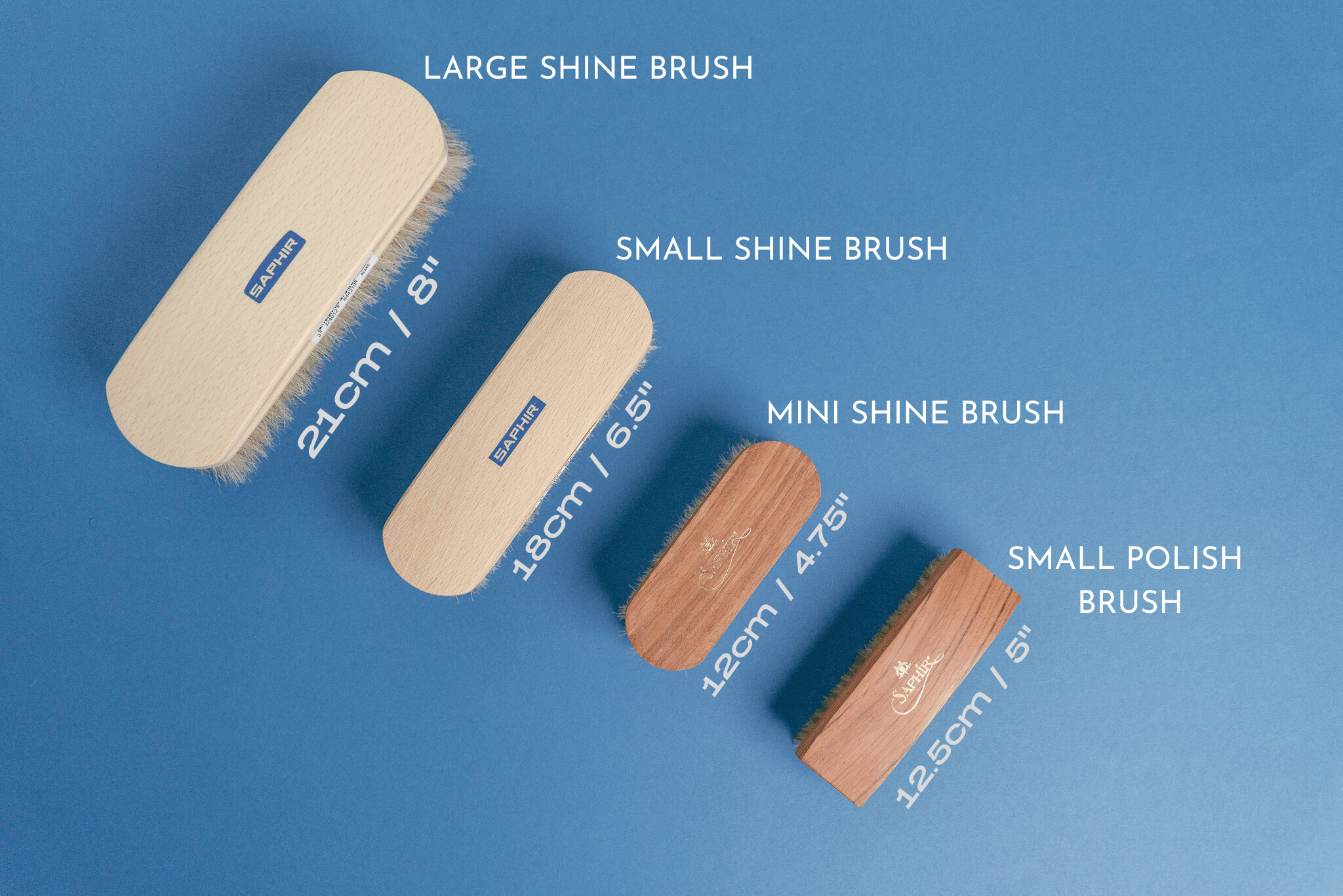 Saphir Beaute De Cuir shine brush displayed in white with Saphir medaille d'or mini horse hair brush and saphir medaille d'or small polish brush to compare sizes 