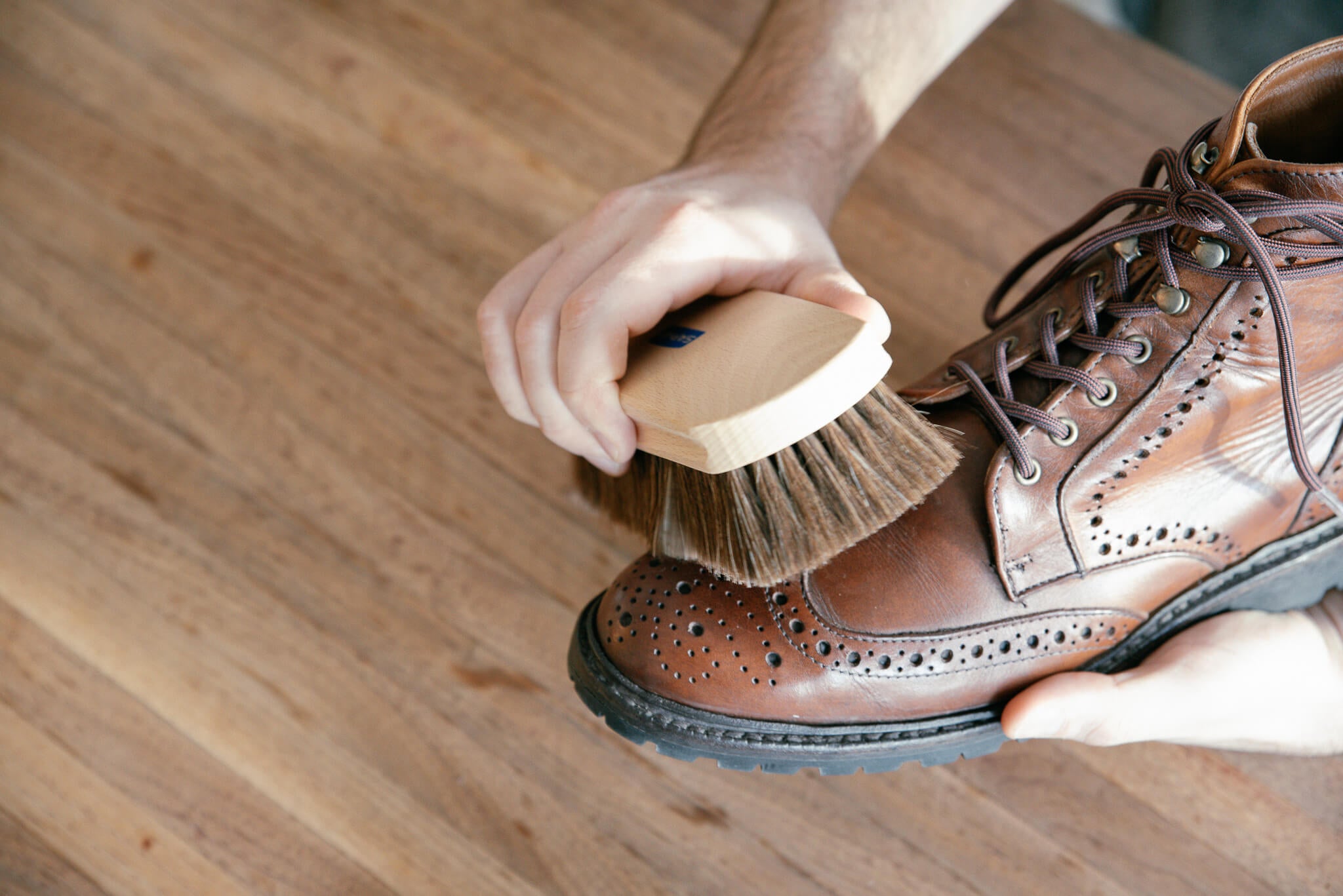 Saphir Beaute De Cuir shine brush shown brushing a pair of allen edmonds long branch cxl boots