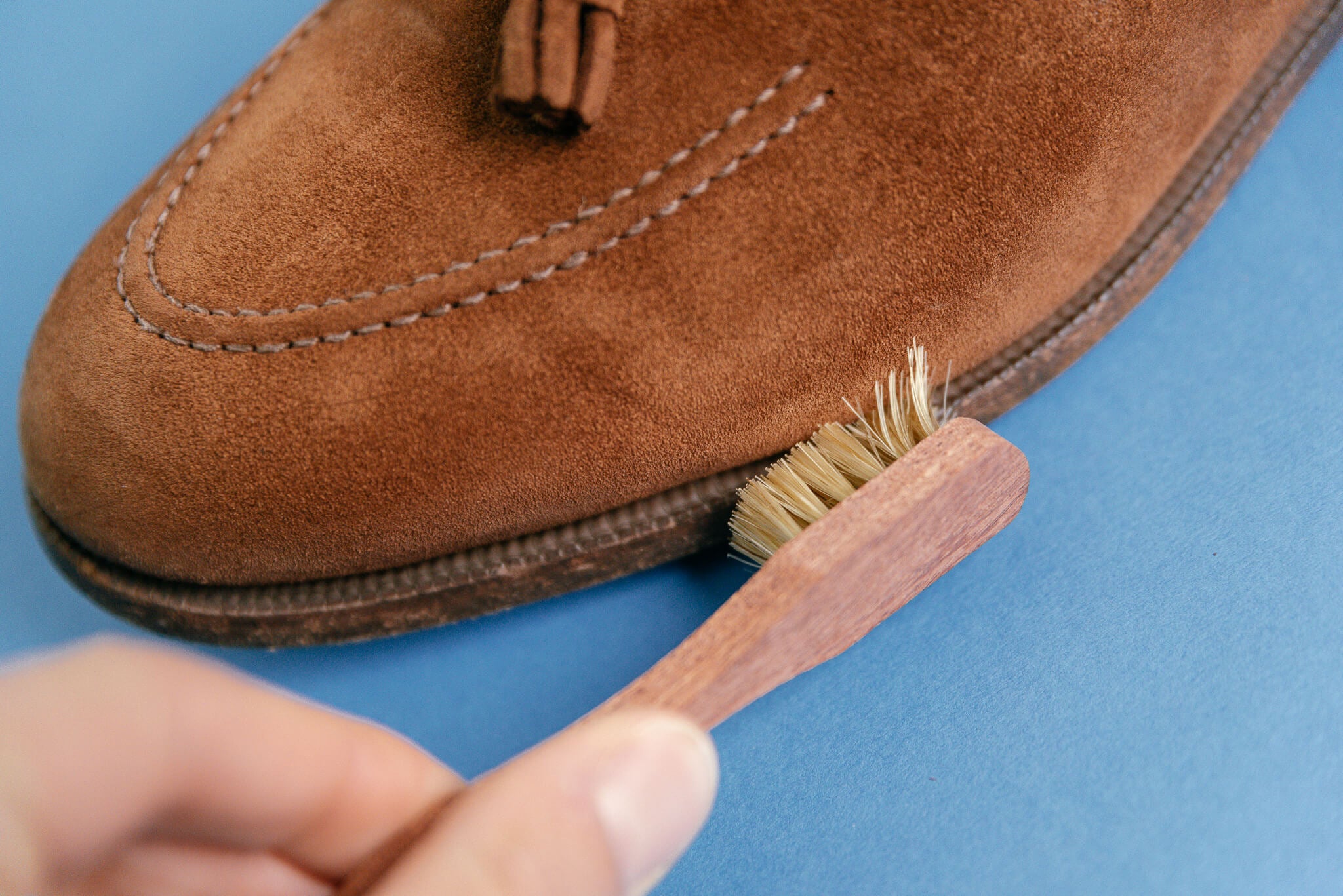 Saphir Medaille d'Or Welt Brush small spatula shown cleaning welt of Crockett & Jones Cavendish loafer in snuff suede